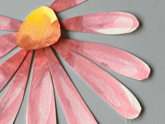 Example of collage art featuring pink flower with yellow center on gray background